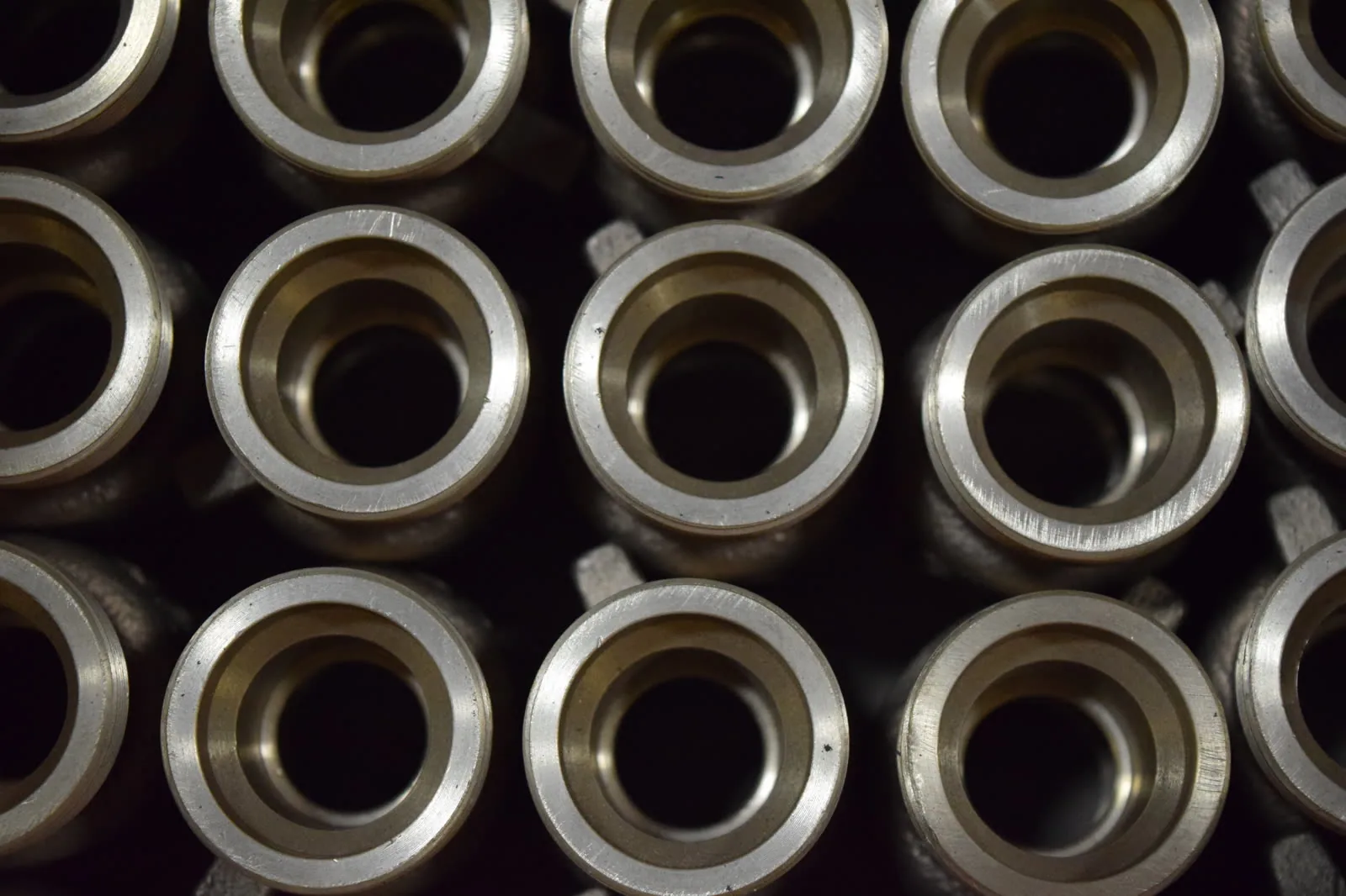 Rows of machined bronze bushings