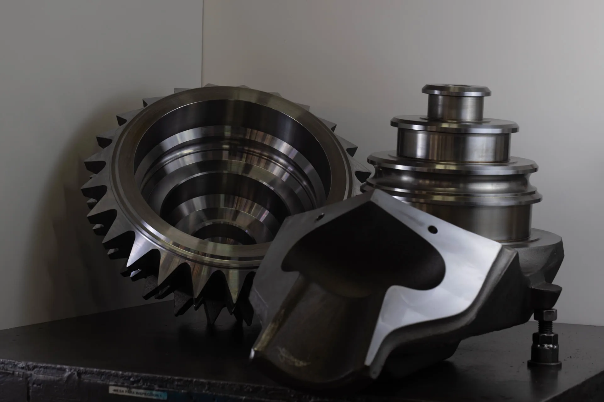 Precision-machined steel components: bevel gear, crankshaft, and stepped shaft