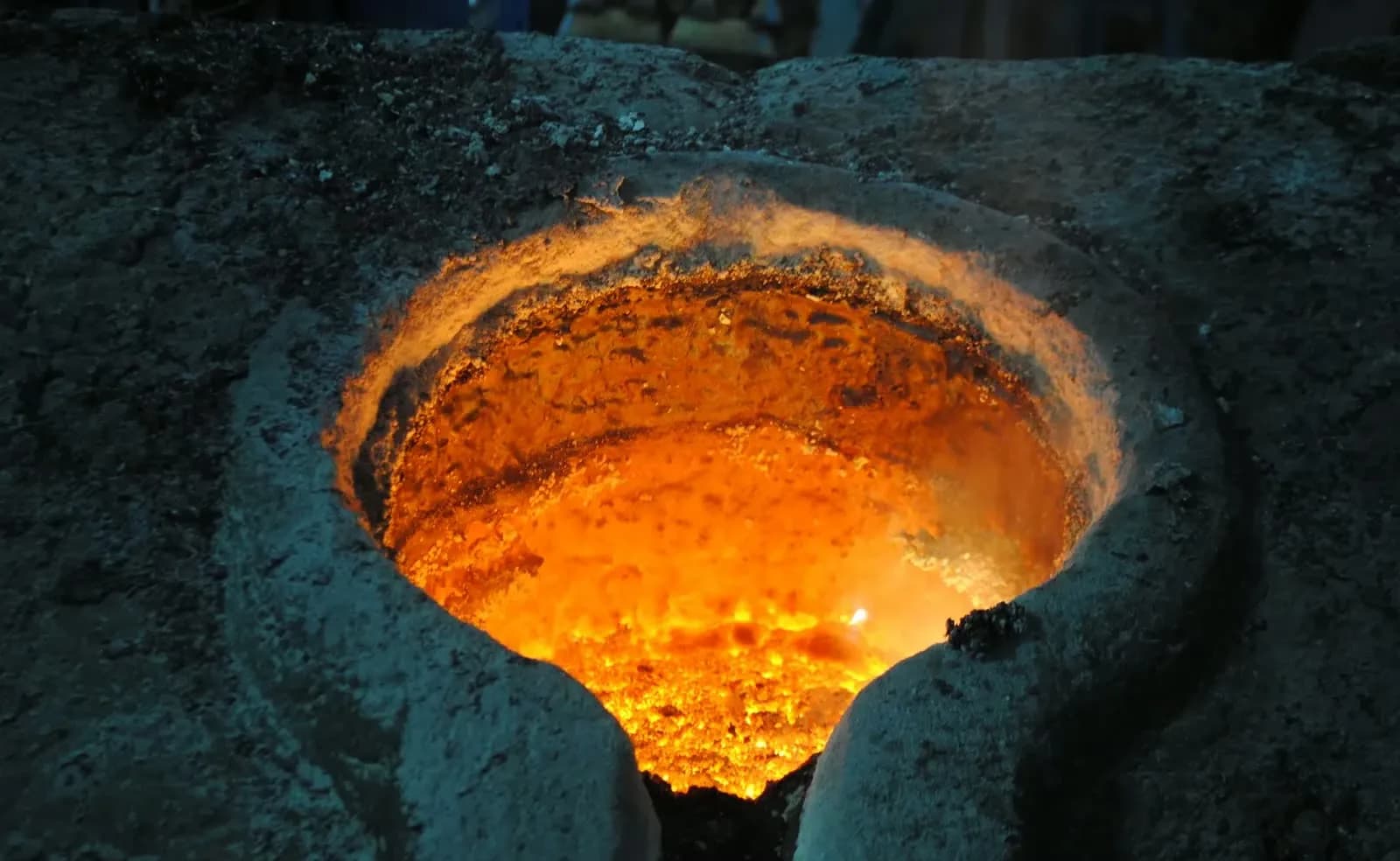 Molten metal glowing in a pouring basin